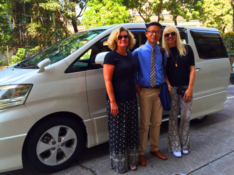 Frank the tour guide takes photos with Valeire in front of the private car for private tour Easy Hong Kong Private Tour