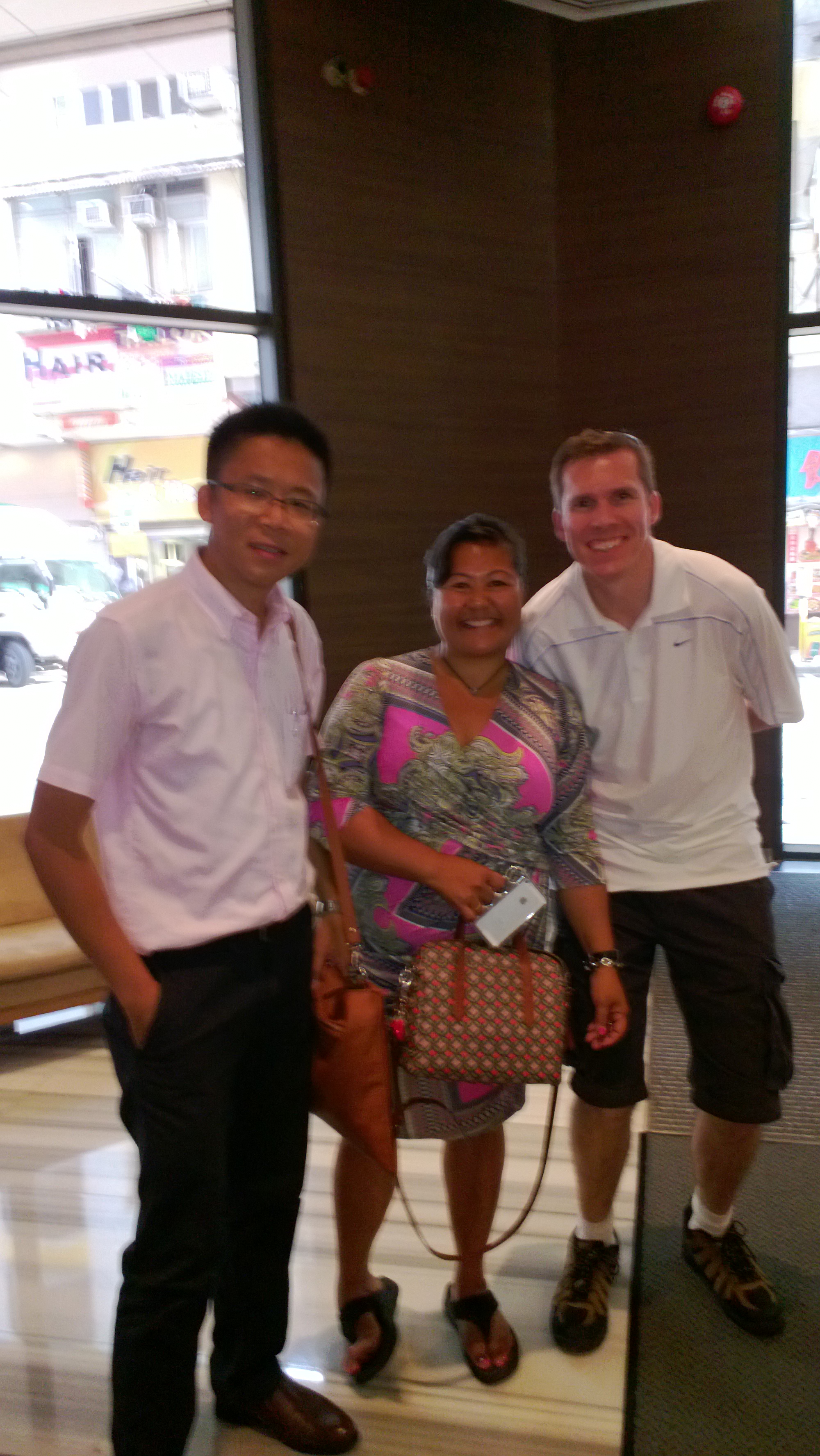 Frank the tour guide takes photo with Isabel M. and her husband at the hotel lobby