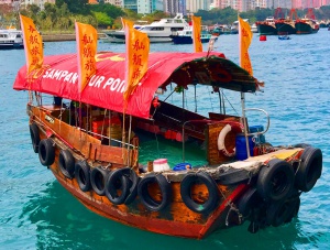 wooden sampan with a red plastic roof on the sea