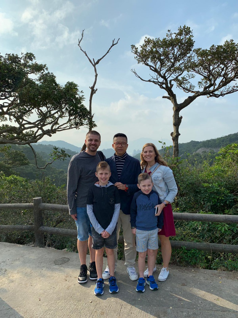 blue sky, green trees, five people