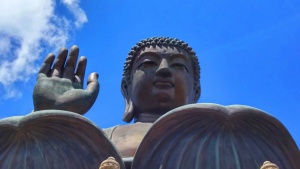 Big Buddha statue close up, blue sky