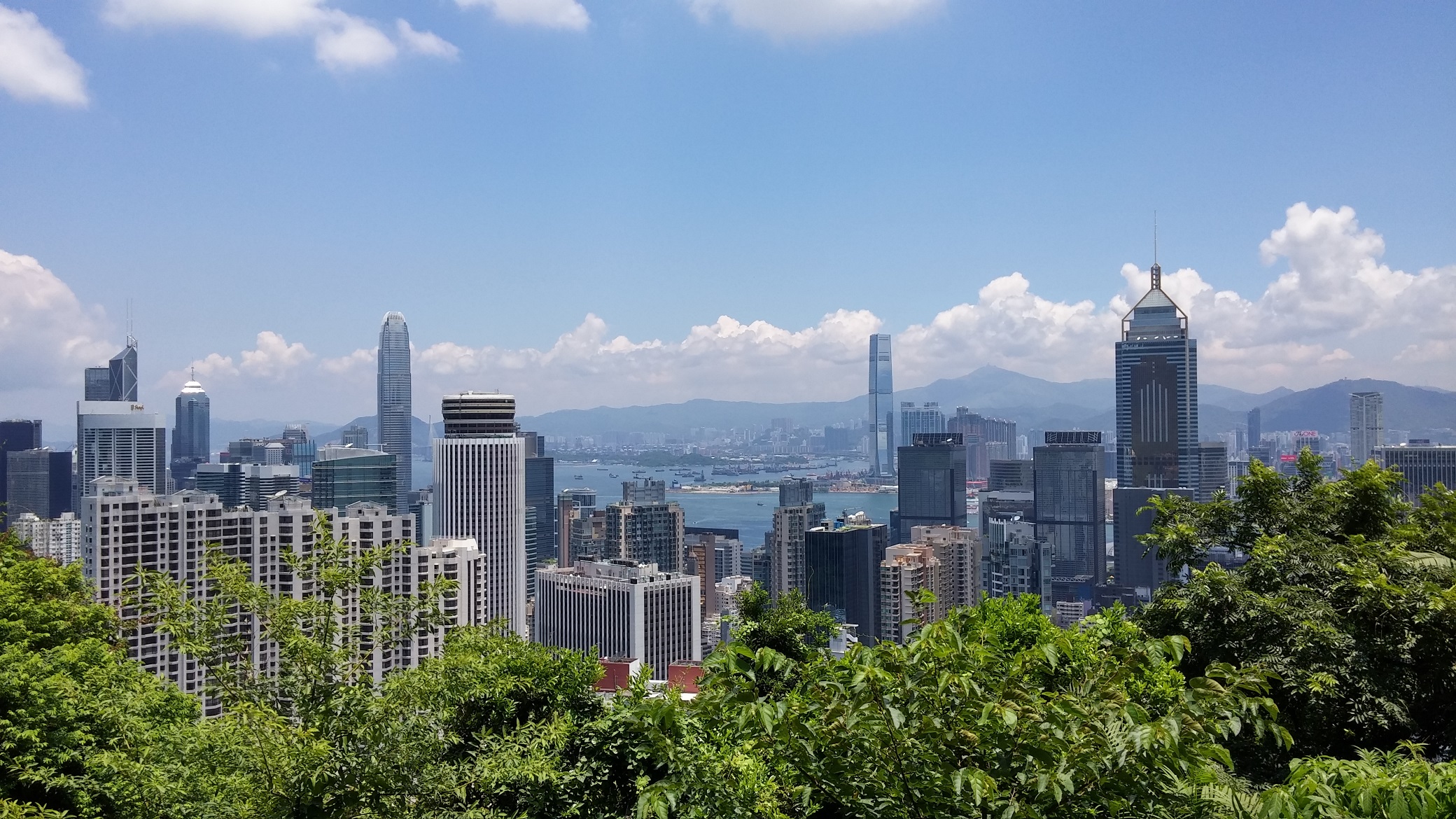 blue clear sky, Hong Kong skyline, harbor, hill, trees